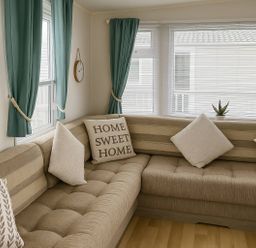 A living room with a sofa and pillows at Whitehouse Leisure Park - Holiday Accommodation 19055 in Towyn, Abergele