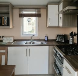 A kitchen with a sink and a stove at Whitehouse Leisure Park - Holiday Accommodation 19057, Towyn, Abergele