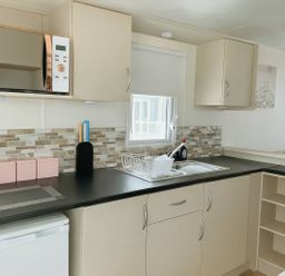 A kitchen with a sink and appliances at Golden Gate Holiday Centre - Holiday Accommodation 19058 Towyn