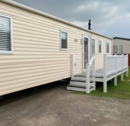 A caravan with steps and windows at Golden Gate Holiday Centre - Holiday Accommodation 19058, Towyn