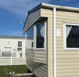 A caravan with windows at Southview Holiday Park - Holiday Accommodation 19123, Skegness