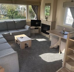 A living room with a sofa and table at Southview Holiday Park - Holiday Accommodation 19123 Skegness