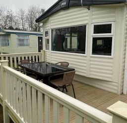 a deck area with a table and chairs at Butlins Skegness - Holiday Accommodation 19332 in Skegness