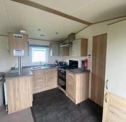 a kitchen with cabinets, appliances, and a window at Butlins Skegness - Holiday Accommodation 19332 Skegness