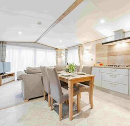 a living room and dining area with a kitchen at Kelling Heath Holiday Park - Holiday Accommodation 19669 in Holt