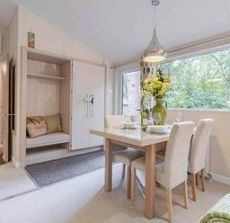 a dining area with a table and chairs overlooking a window at Kelling Heath Holiday Park - Holiday Accommodation 20952, Weybourne