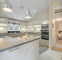 a kitchen with modern appliances and an island at Kelling Heath Holiday Park - Holiday Accommodation 20952 in Weybourne