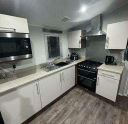 a kitchen with a microwave, oven, sink, and countertop at Butlins Skegness - Holiday Accommodation 21028, Skegness