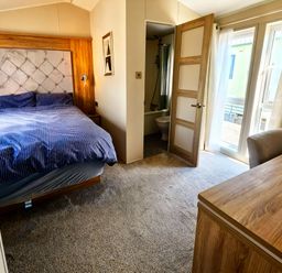 A bedroom with a bed and desk at Ocean Edge Leisure Park - Holiday Accommodation 21286 Morecambe
