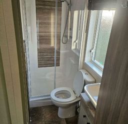 a bathroom with a shower, toilet, and sink at Tattershall Lakes Country Park - Holiday Accommodation 21501, Tattershall