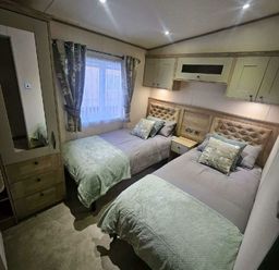 a bedroom with two single beds and a window at Tattershall Lakes Country Park - Holiday Accommodation 21501, Tattershall