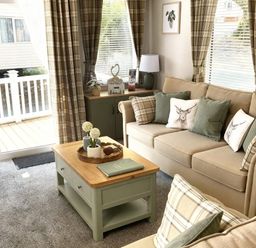 A living room with a sofa and coffee table at Aberdunant Hall Holiday Park - Holiday Accommodation 21962 Prenteg