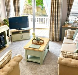 A living room with a television and sofa at Aberdunant Hall Holiday Park - Holiday Accommodation 21962 in Prenteg
