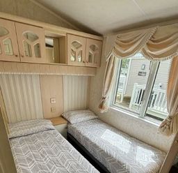 a bedroom with two single beds and a window at Butlins Skegness - Holiday Accommodation 22071 in Ingoldmells