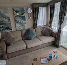 a living room with a sofa, wall art, and coffee table at Ty Gwyn Caravan Park - Holiday Accommodation 22189 Abergele