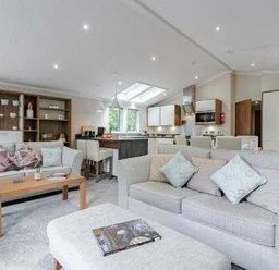 a living room with sofas and a coffee table at Kelling Heath Holiday Park - Holiday Accommodation 22249 in Holt