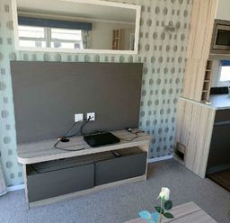 a wall-mounted TV unit with a black device and cables at Lyons Winkups and Primrose - Holiday Accommodation 22330 Towyn