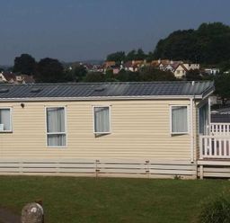 a static caravan with multiple windows and a deck at Waterside, Paignton - Holiday Accommodation 2287, Paignton