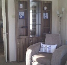 a living room with a glass-fronted cabinet and an armchair at Waterside, Paignton - Holiday Accommodation 2287, Paignton