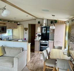 a kitchen and living area with modern furnishings at Lakeland Leisure Park - Holiday Accommodation 3166 Flookburgh