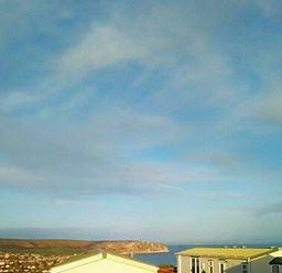 a clear blue sky with some clouds at Swanage Bay View - Holiday Accommodation 464, Swanage