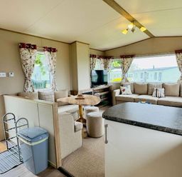 a living room with a sofa, television and dining table at St Andrews Holiday Park - Holiday Accommodation 609 in St. Andrews