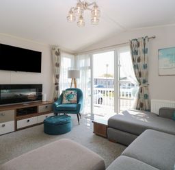 A living room with a sofa and television at Hopton Holiday Village - Holiday Accommodation 632 Hopton-On-Sea