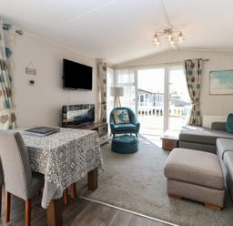 A living room with a table and chairs at Hopton Holiday Village - Holiday Accommodation 632 Hopton-On-Sea