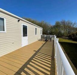 a deck with outdoor seating at Greenacres Holiday Park - Holiday Accommodation 6757 in Porthmadog