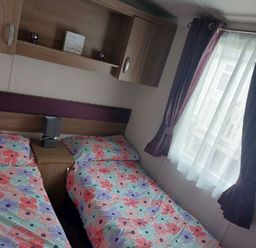 a bedroom with two beds and a window at Reighton Sands Holiday Park - Holiday Accommodation 6837 in Filey