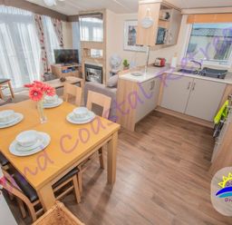 a dining area with a table set for meals in a kitchen and living space at Devon Cliffs Holiday Park - Holiday Accommodation 6955 Exmouth