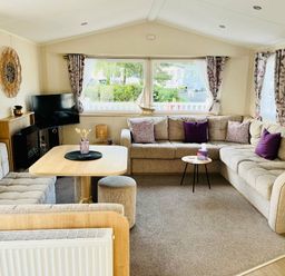 a living room with sectional sofas, a coffee table, and a TV at Hafan y Mor Haven - Holiday Accommodation 7421 Pwllheli