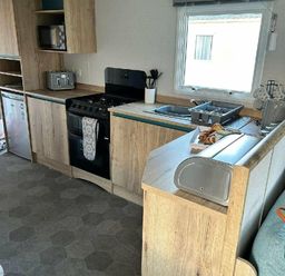a kitchen with cabinets, stove, and sink at Butlins Minehead - Holiday Accommodation 826, Minehead