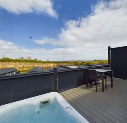 An outdoor area with a hot tub and table at Coniston in Penrith
