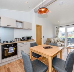 A kitchen with a dining table and chairs at Coniston in Penrith