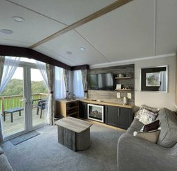 a living room with a television and a coffee table at Perran Sands - Holiday Accommodation 8982 Perranporth