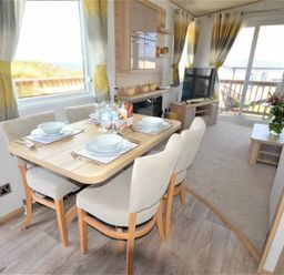 a dining area with a table set for four at Perran Sands - Holiday Accommodation 9657 in Perranporth