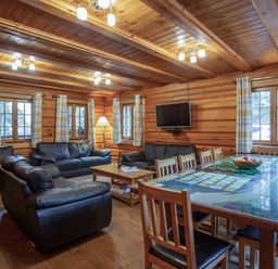 A living room with sofas and a dining table at Kinder Lodge (Pet) Fowlis near Dundee