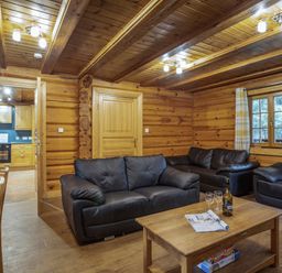 A living room with sofas and a coffee table at Kinder Lodge (Pet) Fowlis near Dundee