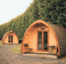 Two wooden garden pods with a pathway at Garden Pod in Waltham