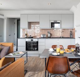 A kitchen with modern furniture and breakfast items at Ferry Hills in Laugharne