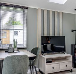 A living room with a table and chairs at Prion Spa in Llandyrnog