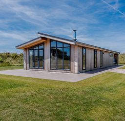 A house with large windows and a patio at Darwin Retreat in Wigton