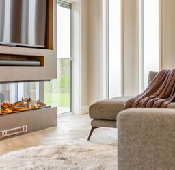 A living room with a television and a fireplace at The Sheraton Retreat in Wigton