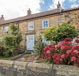 A house with flower beds and greenery at 21 High Street in Scarborough
