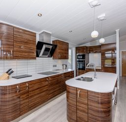 A kitchen with cabinets and an island at Wordsworth in Wigton