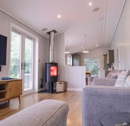 A living room with a fireplace and television at Lawson in Wigton