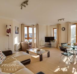 A living room with a sofa and a table at Harbourside Apartment in Weymouth