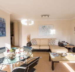 A living room with a sofa and coffee table at Harbourside Apartment in Weymouth