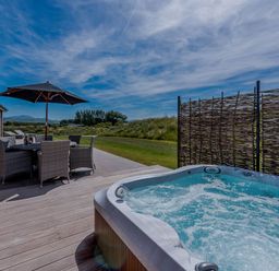 An outdoor area with a hot tub and dining table at Wellington in Wigton